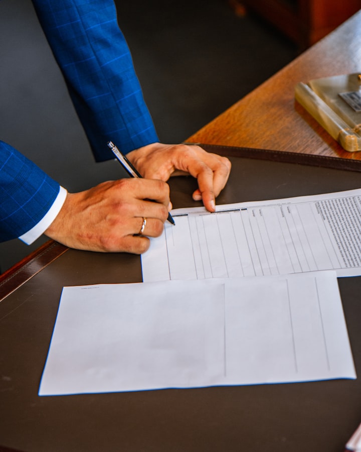 A small-business owner reviewing a stack of paper bills by hand — how every audit starts.